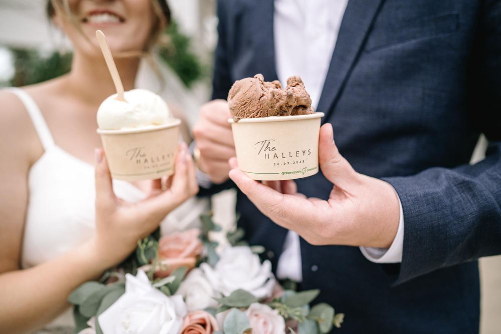 A bride and groom holding personalised cups of gelato